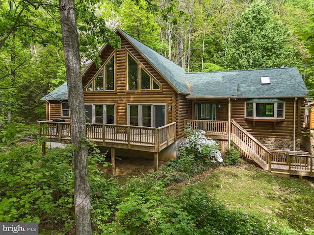 rear view of house featuring a deck