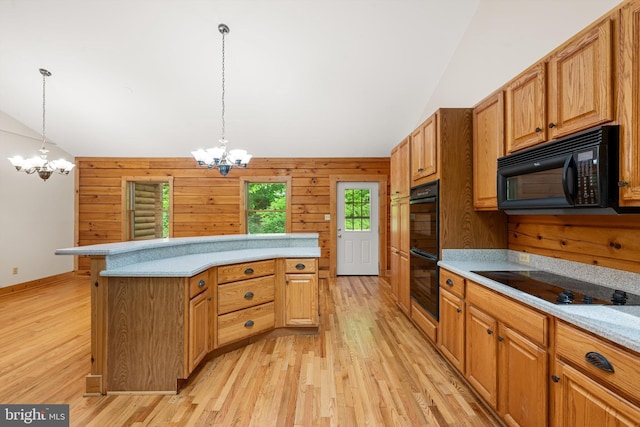 kitchen featuring a chandelier, pendant lighting, lofted ceiling, and black appliances