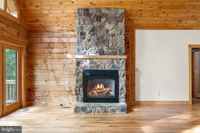 unfurnished living room featuring wooden ceiling, wood-type flooring, a fireplace, and vaulted ceiling