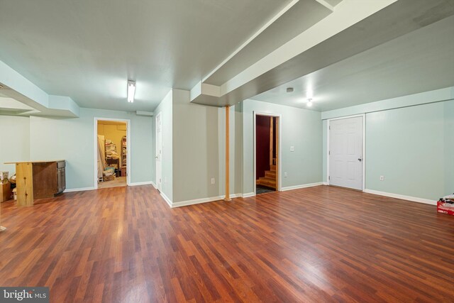 basement with dark hardwood / wood-style flooring