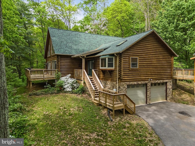 cabin featuring a garage and a deck