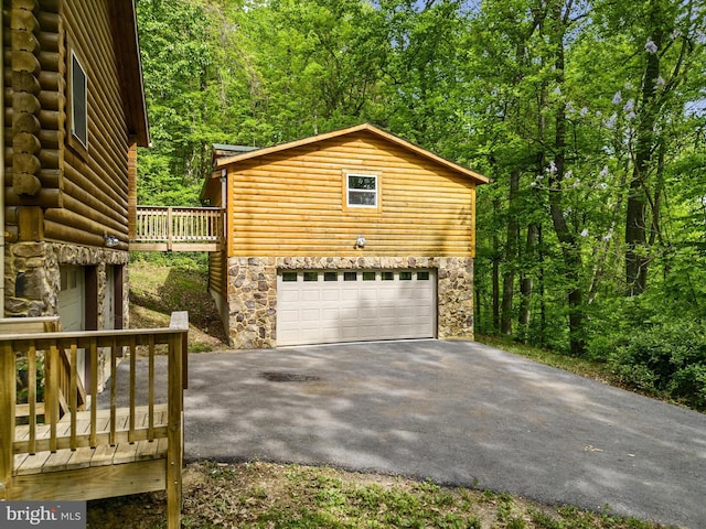 view of property exterior with a deck and a garage