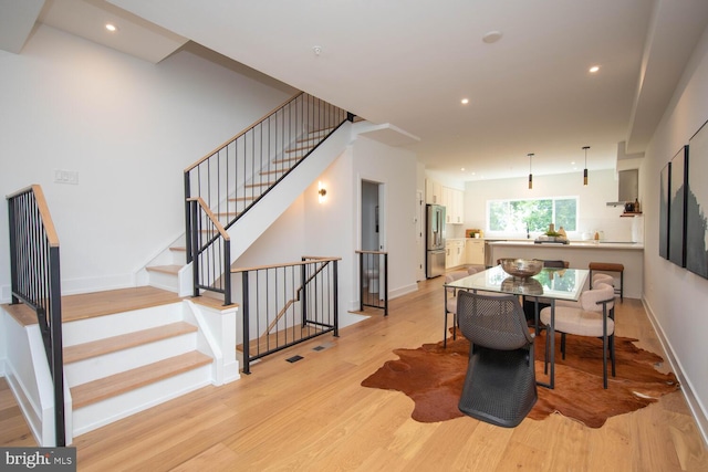 dining space featuring light wood-type flooring