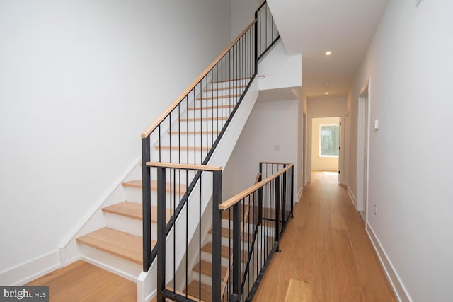 stairs featuring wood-type flooring