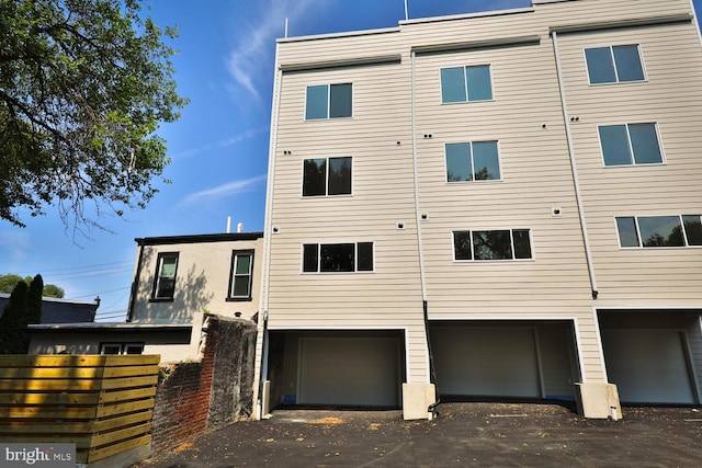 rear view of property with a garage