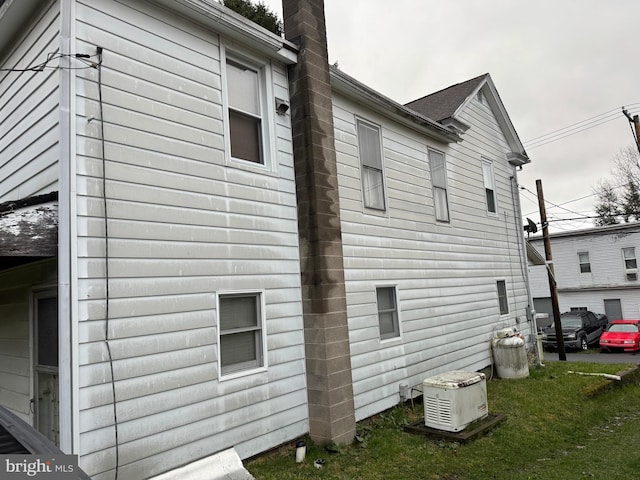 view of side of property with central air condition unit