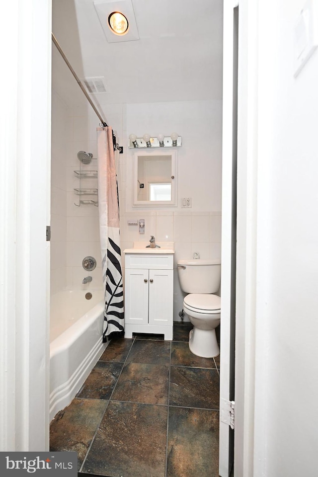 full bathroom featuring shower / bathtub combination with curtain, toilet, tile floors, and vanity