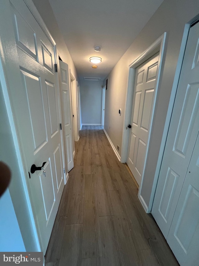 corridor with wood-type flooring