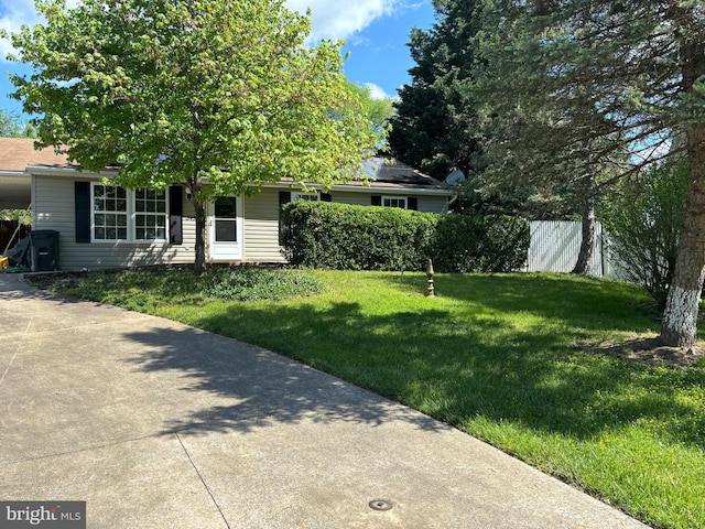 obstructed view of property with a front yard