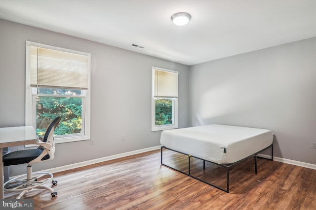 bedroom with hardwood / wood-style flooring