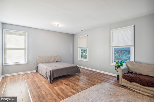 bedroom with hardwood / wood-style floors