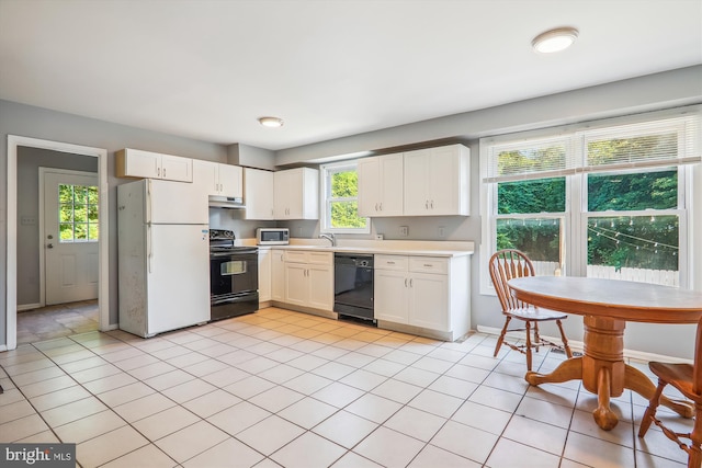 kitchen featuring light tile patterned floors, sink, white cabinetry, and black appliances