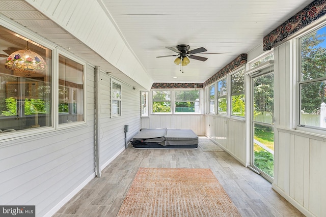 unfurnished sunroom featuring ceiling fan