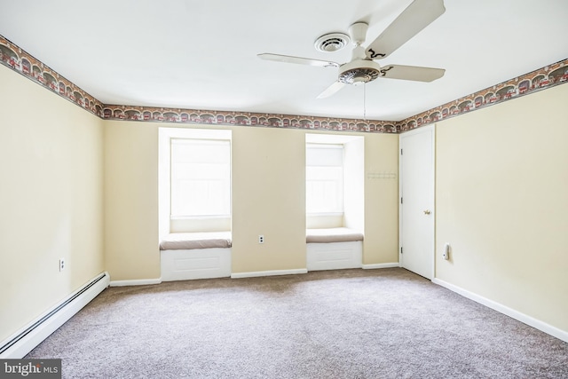 carpeted empty room featuring ceiling fan and a baseboard heating unit