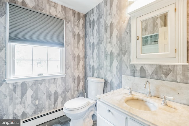 bathroom with tile flooring, large vanity, toilet, and a baseboard heating unit