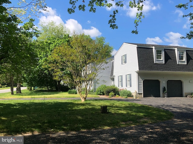 view of property exterior featuring a yard and a garage