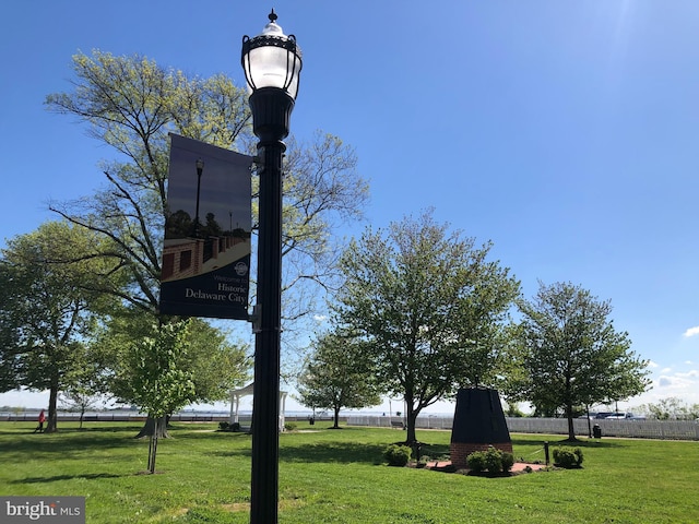 community sign featuring a lawn