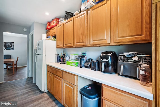 kitchen with dark hardwood / wood-style floors and white refrigerator