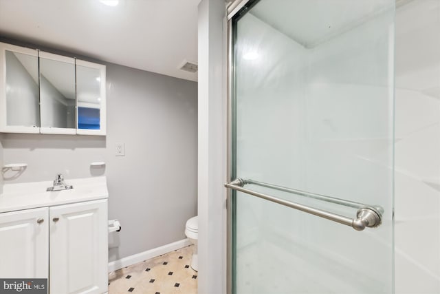 bathroom featuring vanity, toilet, and an enclosed shower