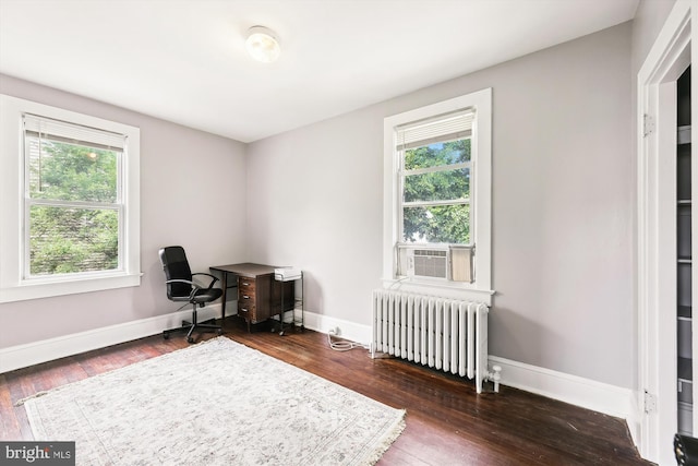 living area with radiator heating unit, cooling unit, and dark wood-type flooring