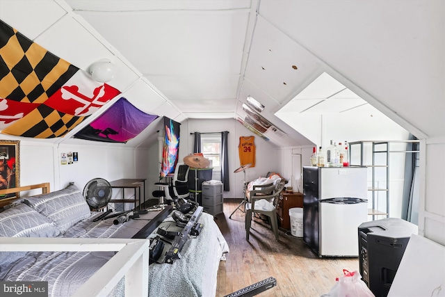 exercise room featuring hardwood / wood-style flooring and lofted ceiling