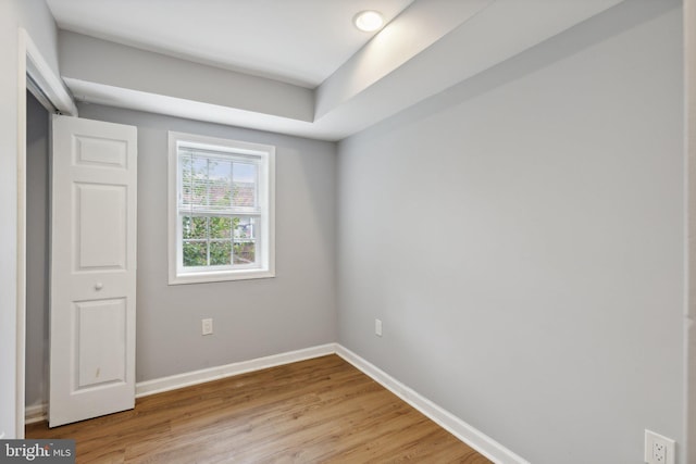 empty room with light hardwood / wood-style flooring