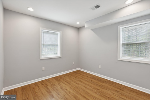 empty room with light hardwood / wood-style flooring