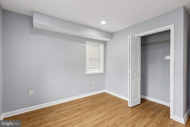 unfurnished bedroom featuring a closet and light hardwood / wood-style flooring