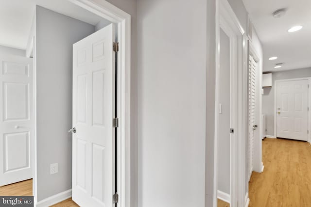 corridor with hardwood / wood-style floors