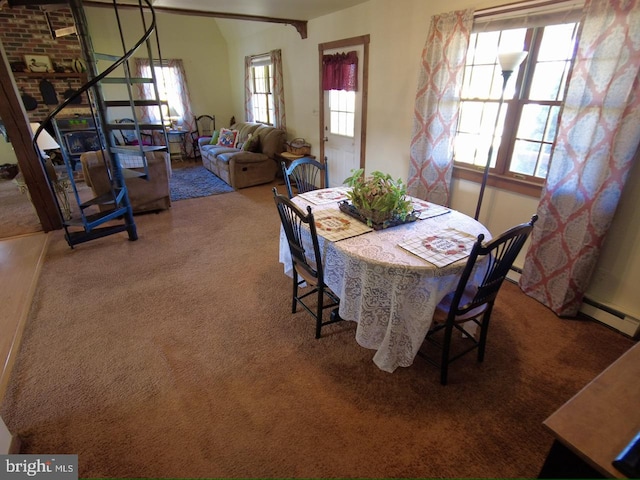 dining area featuring carpet, a wealth of natural light, and a baseboard radiator