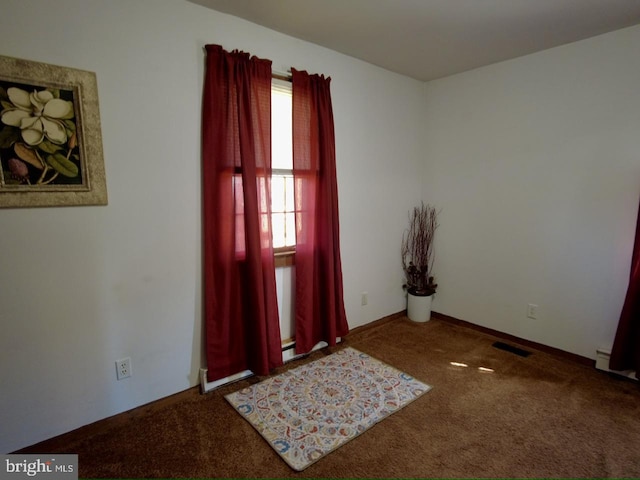 view of carpeted foyer entrance