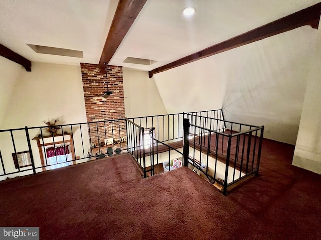 stairs featuring beamed ceiling and carpet floors