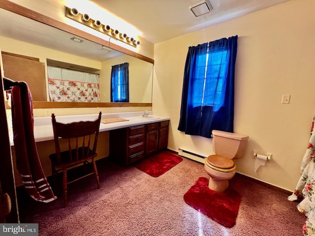 bathroom with vanity, toilet, and baseboard heating