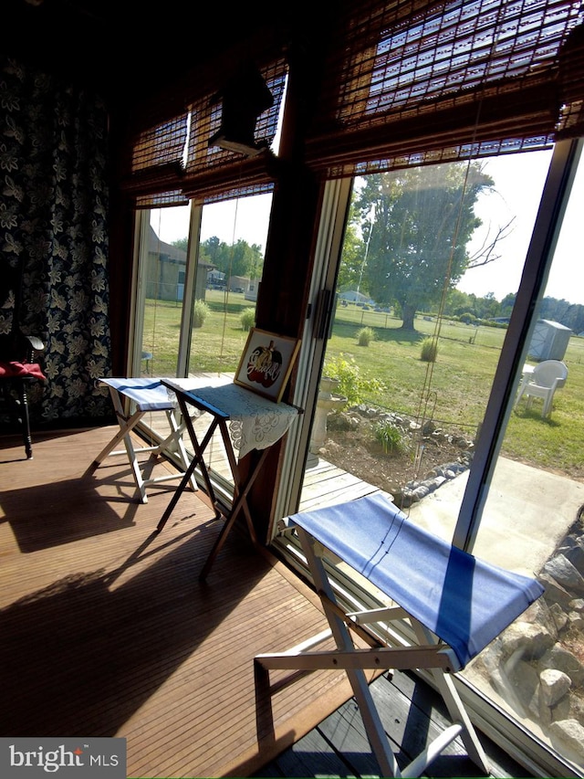 sunroom featuring plenty of natural light and a rural view