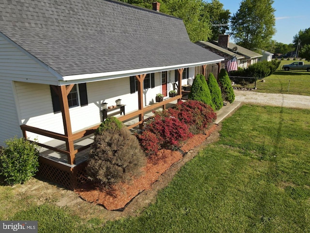 view of home's exterior with a porch and a yard