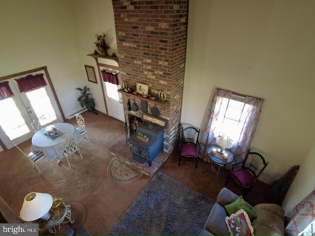 carpeted living room featuring a high ceiling