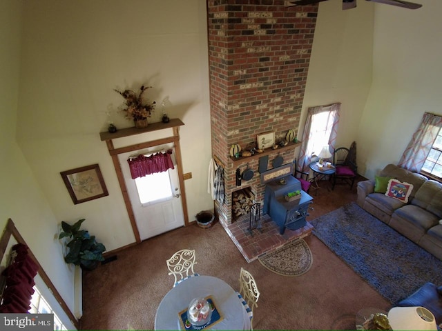 carpeted living room with a high ceiling