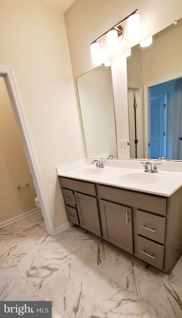 bathroom featuring toilet and vanity