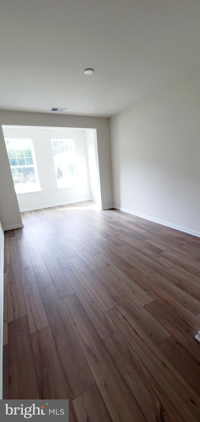 spare room featuring hardwood / wood-style floors