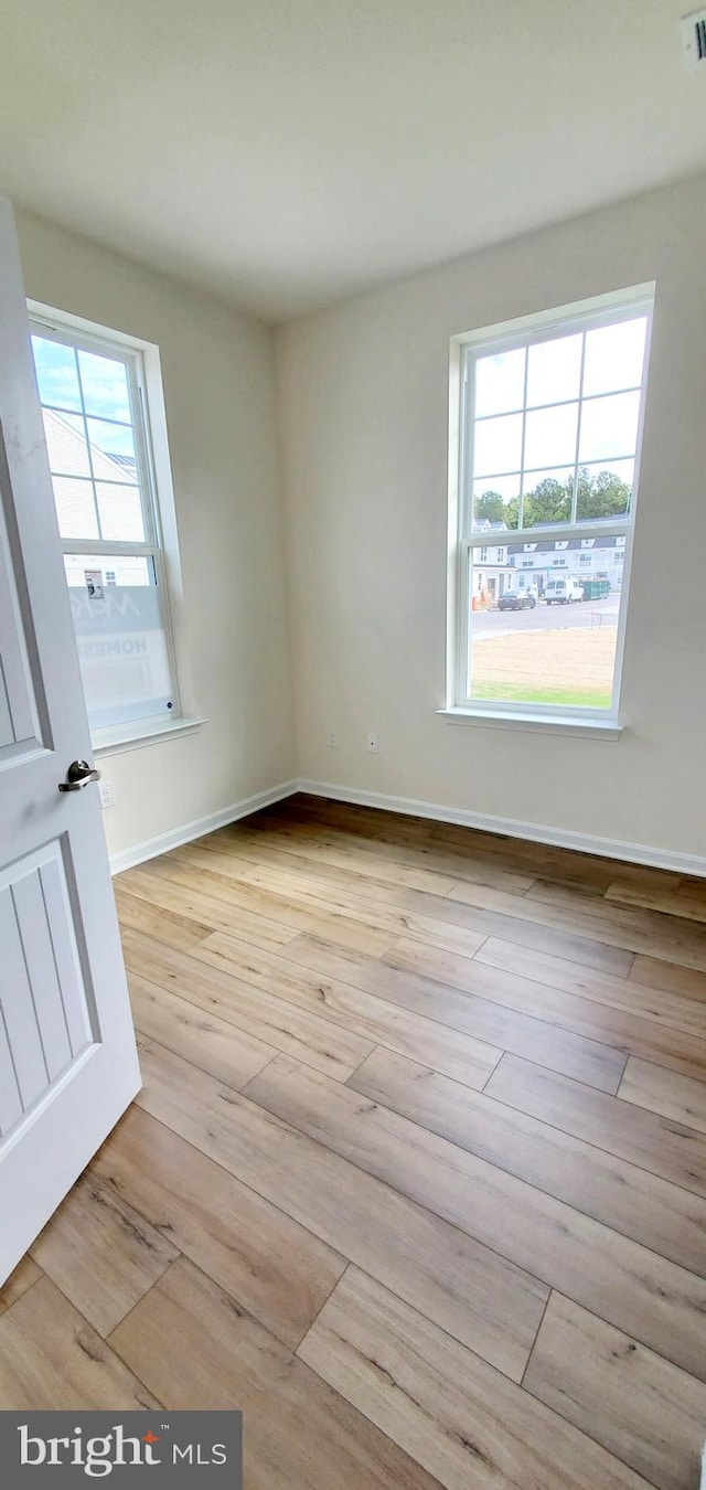 empty room with light hardwood / wood-style floors