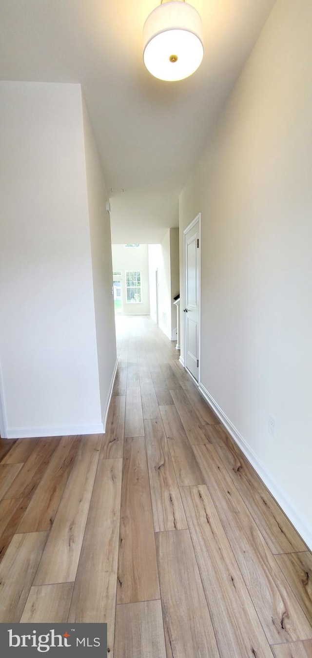 corridor with light wood-type flooring