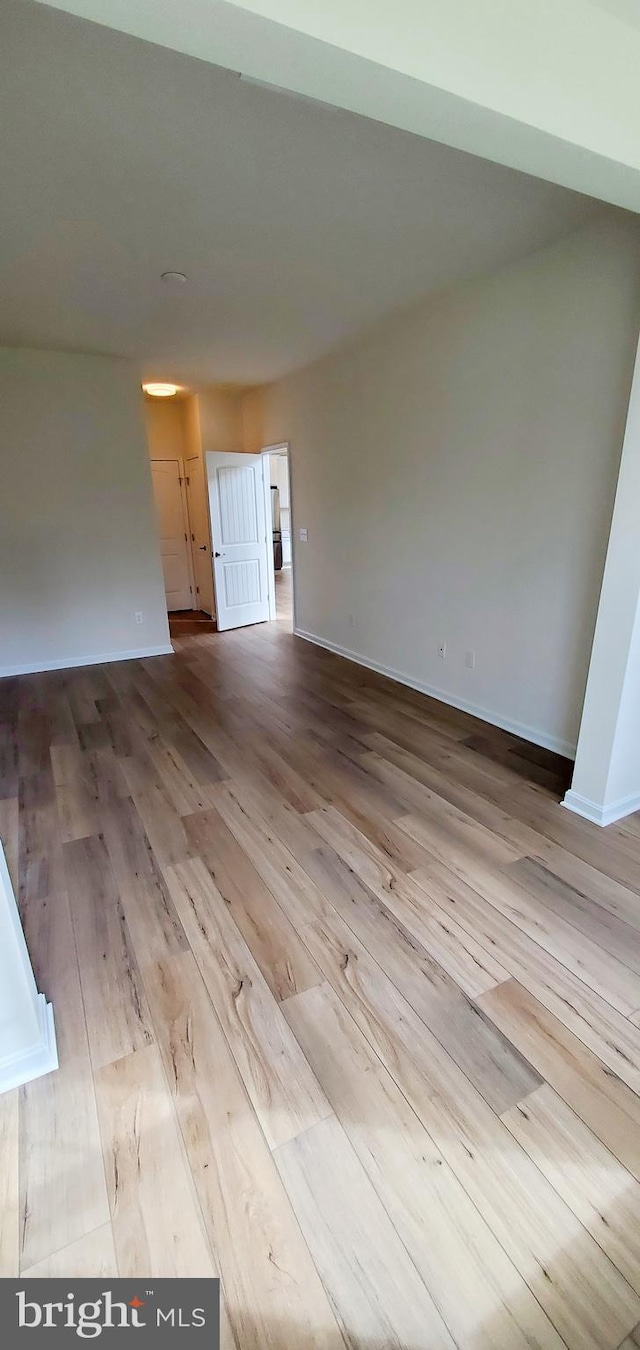 empty room with light hardwood / wood-style flooring