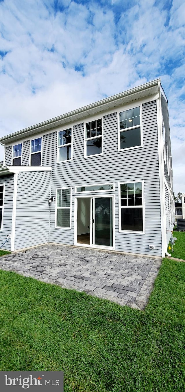 back of house featuring a yard and a patio