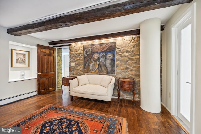 living area featuring dark hardwood / wood-style flooring, beamed ceiling, and a baseboard heating unit