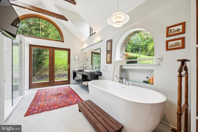 bathroom with sink, beamed ceiling, a bath, and high vaulted ceiling