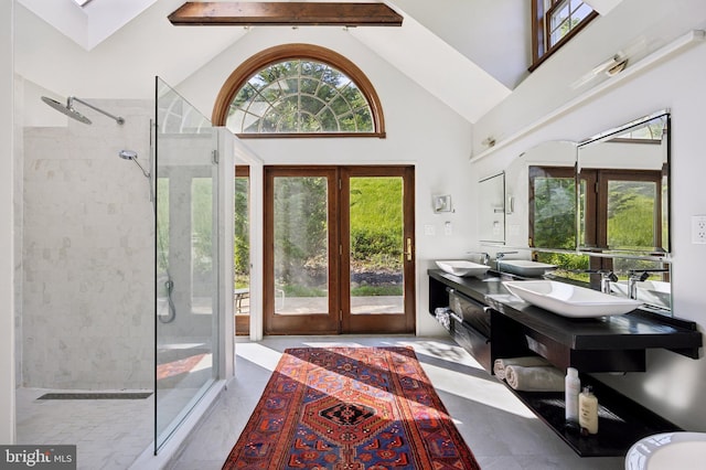 foyer with beamed ceiling, sink, high vaulted ceiling, and french doors