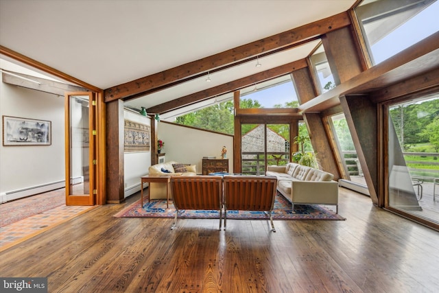 living room featuring beamed ceiling, hardwood / wood-style floors, baseboard heating, and a wealth of natural light