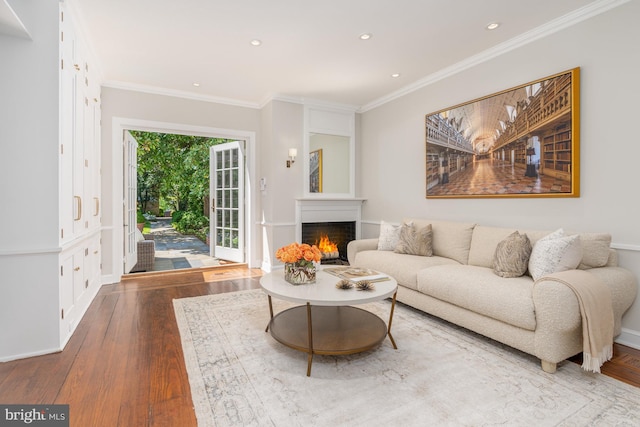 living room with crown molding and hardwood / wood-style flooring