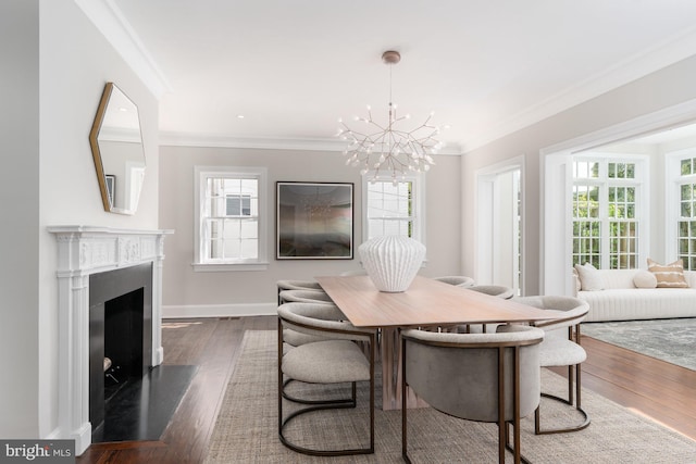 dining area featuring crown molding, dark wood-type flooring, and an inviting chandelier