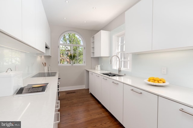 kitchen featuring white cabinetry, sink, dark hardwood / wood-style floors, and black electric stovetop